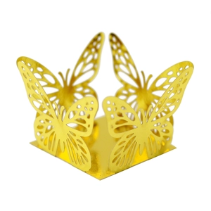 Detailed view of hollow butterfly pattern with metallic gold mirror finish on a wedding candy box