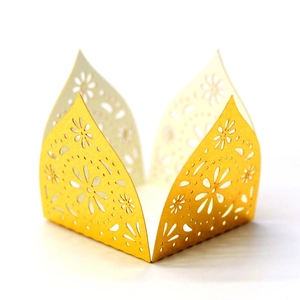 Detailed laser-cut gold pearlescent paper wrapper with intricate floral patterns