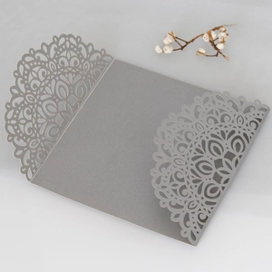 Elegant laser-cut mandala lace wedding invitation cover in pearlescent silver paper