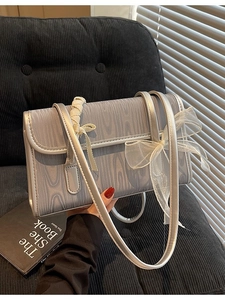 Fashionable light blue shoulder bag with wave texture and white mesh bow decoration