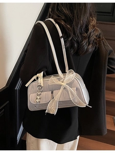 Silver metallic saddle bag with lace bow and heart charm on casual shoulder strap