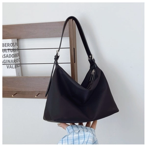 Detail of the adjustable strap and silver metal buckle on black crescent Hobo bag