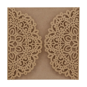 Macro detail of laser-cut mandala patterns on dark brown kraft paper wedding invitation