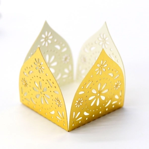 Detail of laser-cut floral pattern on golden decorative party candy gift box