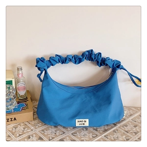 Detail der blauen Falten-Tasche mit Scrunchie-Griff und sicherem Reißverschluss