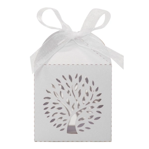 Close-up of laser-cut Tree of Life pattern on white wedding favor box with ribbon bow