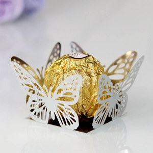 Macro detail of laser cut butterfly hollow paper favor box for wedding and party candy