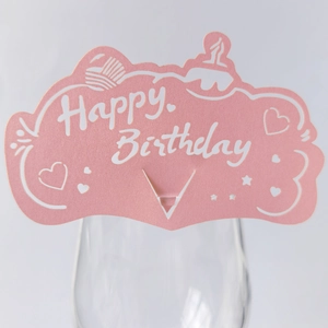 Pink Happy Birthday laser-cut paper wine glass card with heart and star motifs for party decor