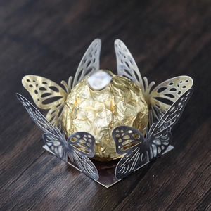 Detailed view of silver laser-cut butterfly wrapper for chocolates and wedding desserts