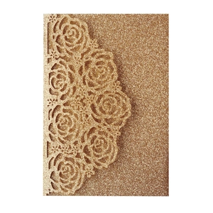 Detailed laser-cut rose pattern on gold glitter wedding invitation card with intricate hollows