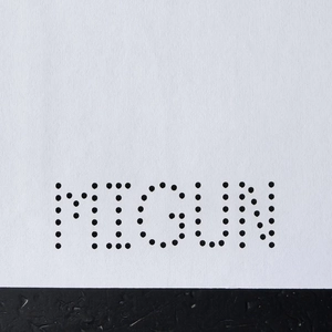 Laser cut A4 paper showing precision perforated MIGUN logo in minimalist dot matrix pattern