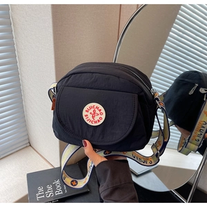Detail of black nylon shoulder bag with SIJICHAO logo and jacquard woven strap