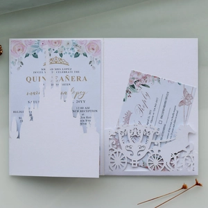 Detail of laser-cut golden castle and pumpkin carriage silhouette wedding invitation card