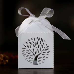 Detailed laser-cut tree design on white pearlescent candy box with sheer organza ribbon