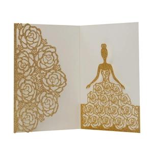 Detail of laser-cut gold glitter wedding invitation featuring rose patterns and a girl silhouette