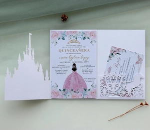 Laser-cut castle wedding invitation set with floral inner card on soft fabric background