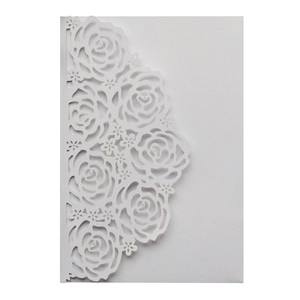 Detailed laser-cut rose patterns on elegant white pearlescent paper invitation card