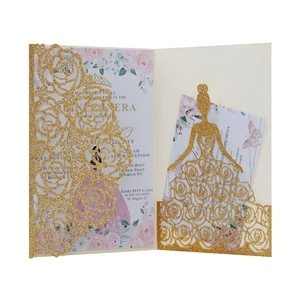 Macro detail of laser-cut glitter gold Quinceañera invitation with floral inserts