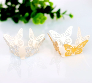 Macro detail of laser-cut butterfly candy box with gold and silver hollow lace design