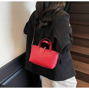 Detailed macro view of red crocodile pattern PU leather tote with silver metal hardware