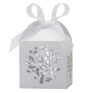 Macro detail of laser-cut Tree of Life on white pearlescent paper wedding gift box