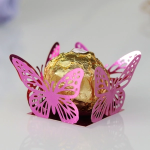 Detail view of pink laser-cut butterfly chocolate box with shiny metallic finish