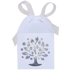 Detail of laser-cut tree pattern on a white house-shaped gift box with a satin bow