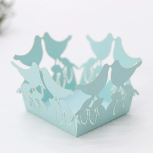 Detailed laser-cut light blue bird design on paper candy box lace edging decoration
