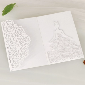 Detail of laser-cut wedding invitation featuring rose patterns and a girl's dress silhouette