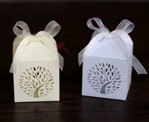 Detailed laser-cut tree of life wedding favors boxes with elegant organza ribbons