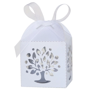 Detail showing white laser-cut tree pattern on wedding favor box with ribbon bow