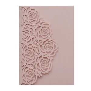 Detailed laser-cut rose pattern on light pink hollowed-out wedding invitation sleeve