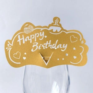 Golden laser-cut Happy Birthday cup card decoration with heart and star cutout patterns