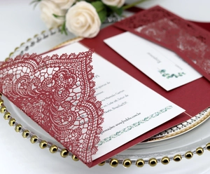 Burgundy laser-cut wedding invitation set with floral hollow pattern and RSVP cards