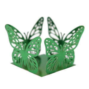Detail of green laser cut butterfly candy box with intricate lace pattern for parties
