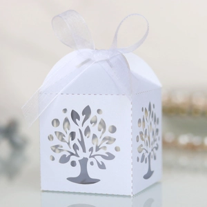 Detail of laser-cut Tree of Life candy box with white organza ribbon for weddings