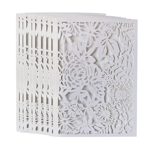 Elegant white laser-cut wedding invitation featuring intricate rose and leaf floral patterns