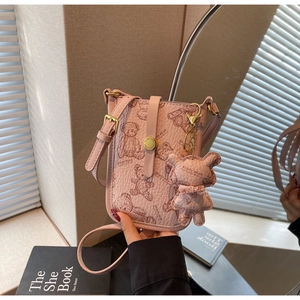 Detail of pink PU leather phone bag with brown teddy bear print and a gold magnetic clasp