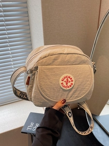 Fashionable beige nylon square crossbody bag with wide logo strap and front pocket