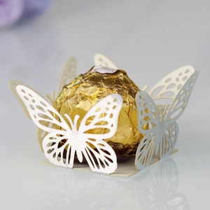Detail of laser-cut butterfly cupcake wrapper made of light silver pearlescent paper