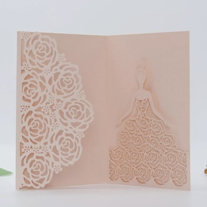Close-up of pink laser-cut floral invitation featuring a rose dress girl silhouette