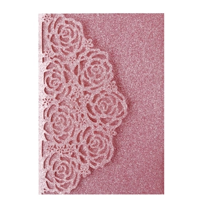 Detail of pink glitter laser-cut rose lace pattern on an invitation card sleeve