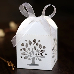 Detail of white tree design laser-cut gift box with elegant organza ribbon bow