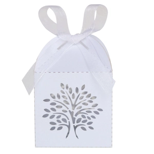 Detailed view of white laser-cut hollow tree candy box with white ribbon bow