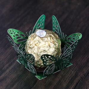 Detail of green butterfly laser-cut hollow paper holder for chocolate candies