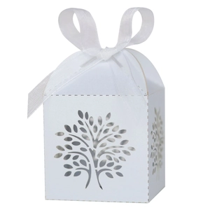Detail showing white laser-cut tree gift box with a decorative satin ribbon bow