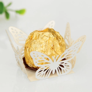 Detail of laser-cut butterfly chocolate holder with intricate hollow patterns on pearl paper