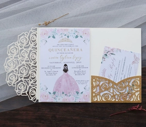 Detail of laser-cut rose invitation with Quinceañera girl print on dark wood backdrop