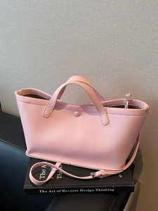 Chic pink lychee texture leather bucket bag shown as a versatile shoulder and handbag