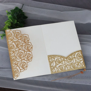 Detail of glitter champagne gold rose laser-cut invitation with pocket for wedding